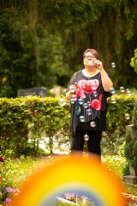 Steffi als Trauerrednerin neben auf dem Kinder-Friedhof mit Seifenblasen